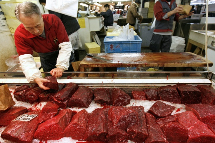 A wholesaler prepares to sell whale meat at the Tsukiji fish market in Tokyo December 12, 2006.
