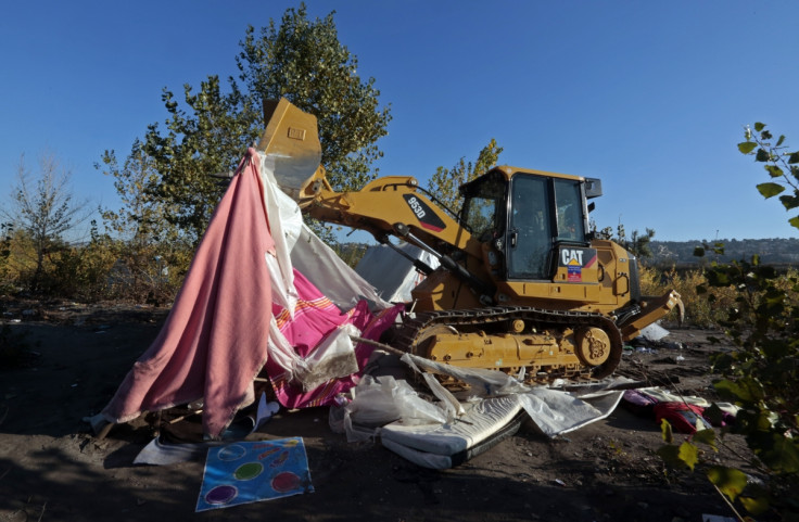 A digger clears the site after the eviction of Roma families from their illegal camp near the bank of the Var river in Nice, southeastern France