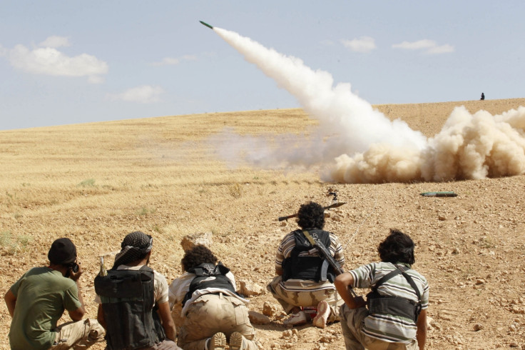 Free Syrian Army fighters fire a rocket towards forces loyal to Syria's President Bashar al-Assad in Hama countryside