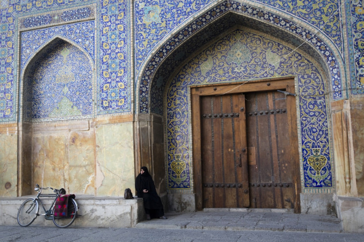 An Iranian woman observes prayers while sitting outside the Imam Khomeini mosque at the historical Naqsh-e Jahan Square in Isfahan (Getty)