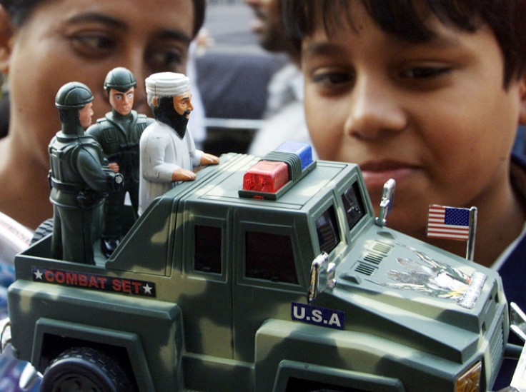 Bangladeshi children play with a toy depicting Osama bin Laden riding on the back of a jeep after being arrested by the US military.