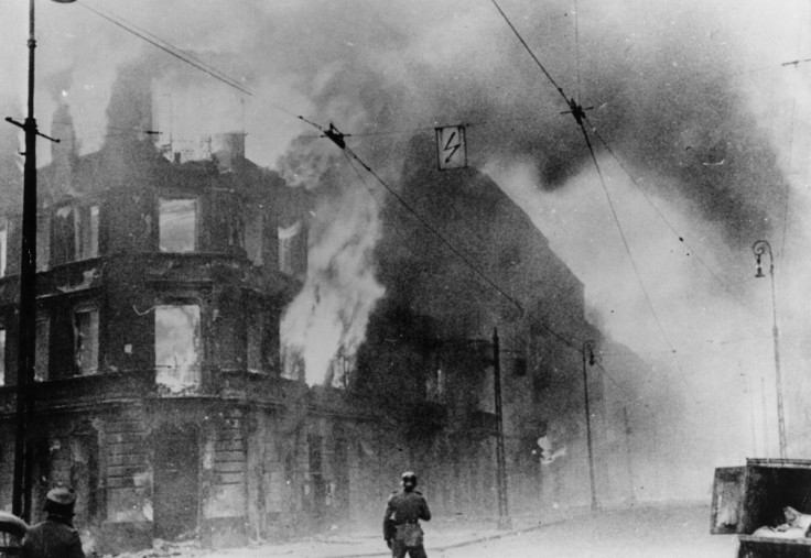 A building burns during the first Warsaw uprising in 1943 (Getty)