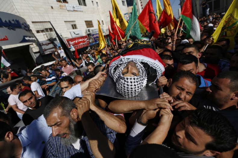 Mourners carry the body of Palestinian Mohammed Attallah during his funeral in the West Bank city of Ramallah