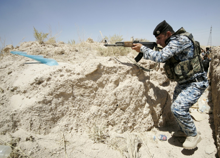 A member of the Iraqi security forces takes position during a patrol looking for militants of the Islamic State of Iraq and the Levant (ISIL) at the border between Iraq and Saudi Arabia