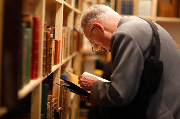 Elderly man reading book