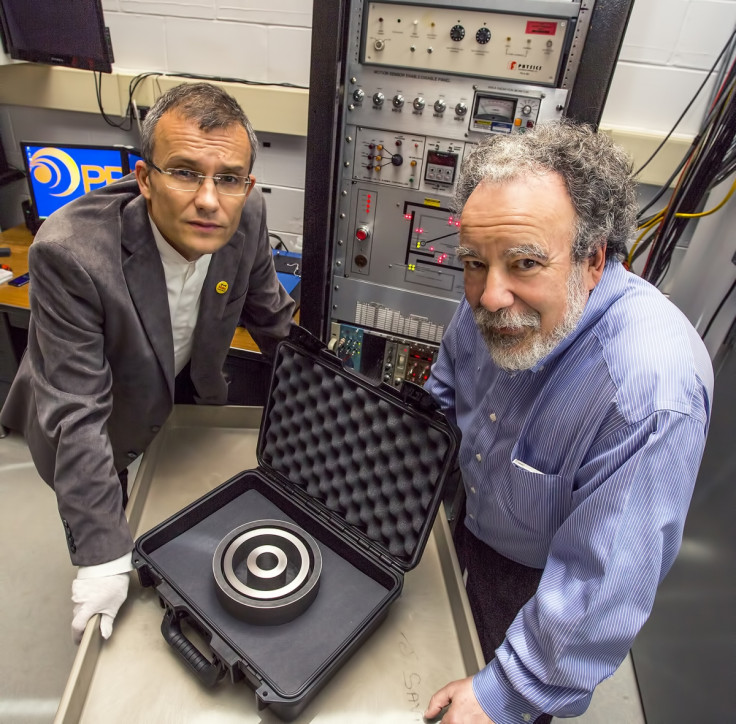 Physicists Alexander Glaser, left, and Robert Goldston, display the non-nuclear test object that will serve as a target in their research.