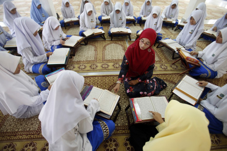 Muslim schoolgirls recite verses from the Quran on the occasion of "Nuzul Al-Quran"