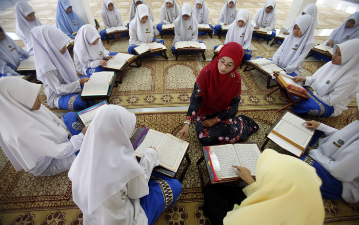 Muslim schoolgirls recite verses from the Quran on the occasion of "Nuzul Al-Quran"