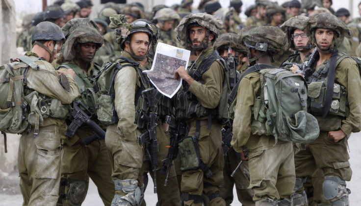 Israeli soldiers take part in an operation to locate three Israeli teens