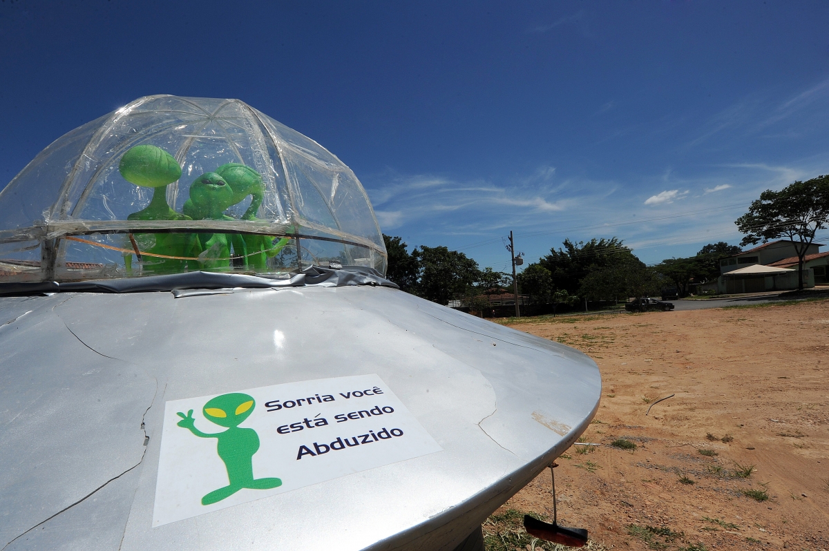 A mock UFO with alien dolls and reading 'Smile, you are being abducted' is seen in Alto Paraiso town, Goias State