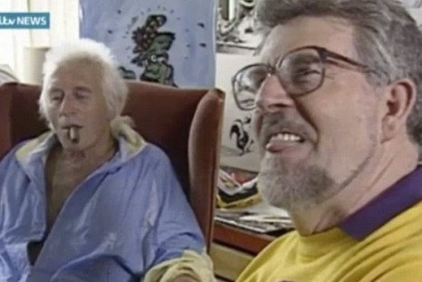 Child sex abuser Rolf Harris licks his lips while enjoying time with fellow paedophile Jimmy Savile