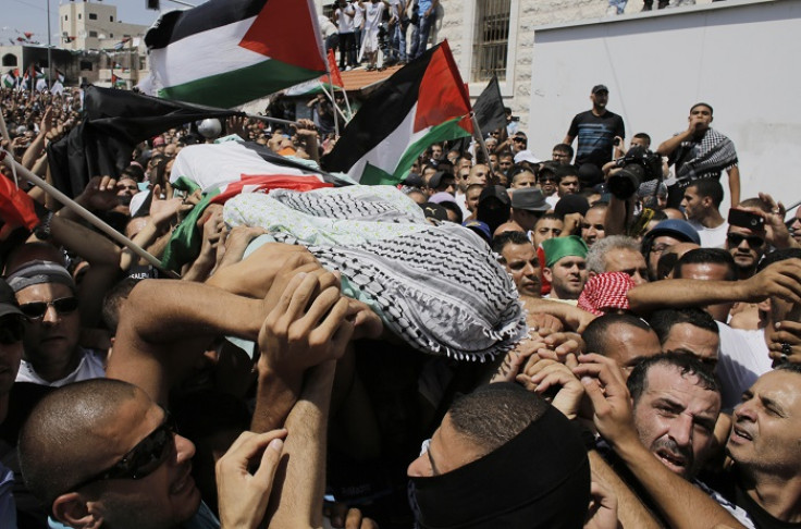 Palestinians carry the body of Mohammed Abu Khudair during his funeral in Shuafat, an Arab suburb of Jerusalem on 4 July 2014.