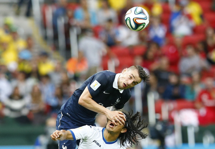 Don't look now: France's Mathieu Debuchy fights with Roger Espinoza of Honduras for the ball during their 2014 World Cup Group E soccer match at the Beira-Rio stadium in Porto Alegre