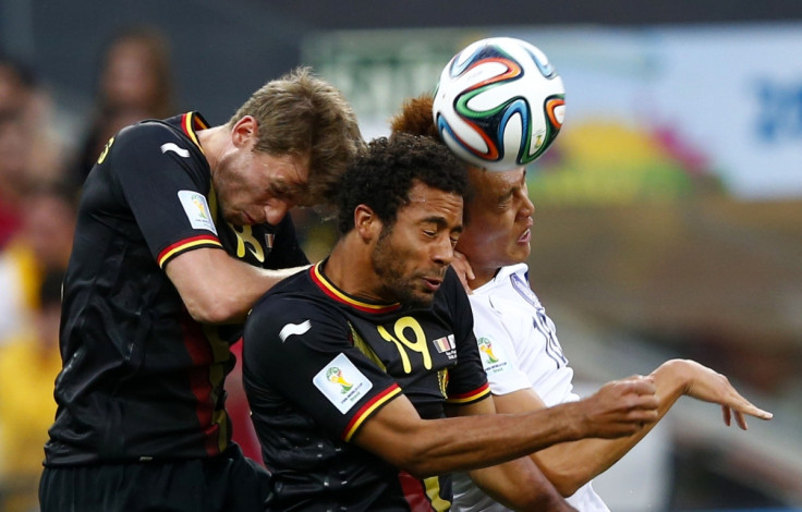 Doing the hand jive: South Korea's Kim Shin-wook (R) fights for the ball with Belgium's Nicolas Lombaerts (L) and teammate Moussa Dembele during their 2014 World Cup Group H soccer match at the Corinthians arena in Sao Paulo