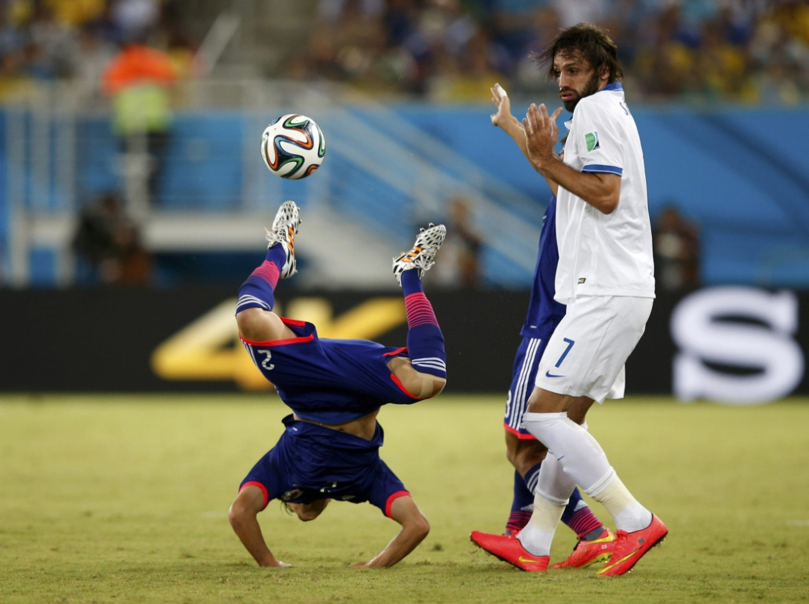 I didn't touch him, says Greece's Giorgios Samaras, after committing a foul against Japan's Atsuto Uchida (L) I didn't touch him, says Greece's Giorgios Samaras, after committing a foul against Japan's Atsuto Uchida (L)
