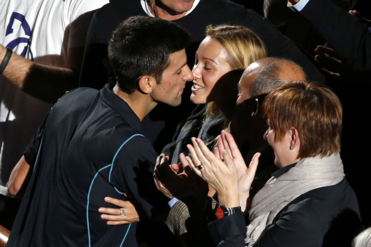 Novak Djokovic of Serbia (L) kisses his fiancee Jelena Ristic (C) after he defeated David Ferrer of Spain in their final match at the Paris Masters men's singles tennis tournament at the Palais Omnisports of Bercy in Paris,