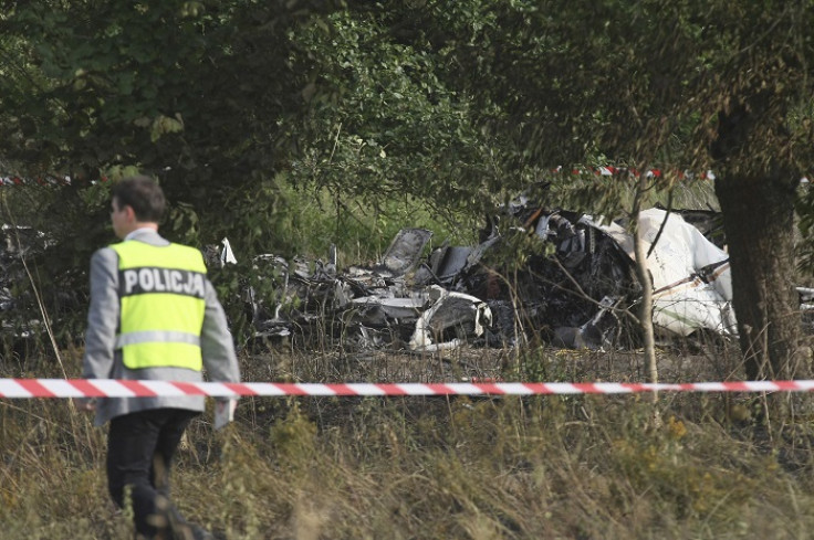 A policeman inspects the site of the crash of the Piper PA-31 Navajo plane in Topolow near Czestochowa.