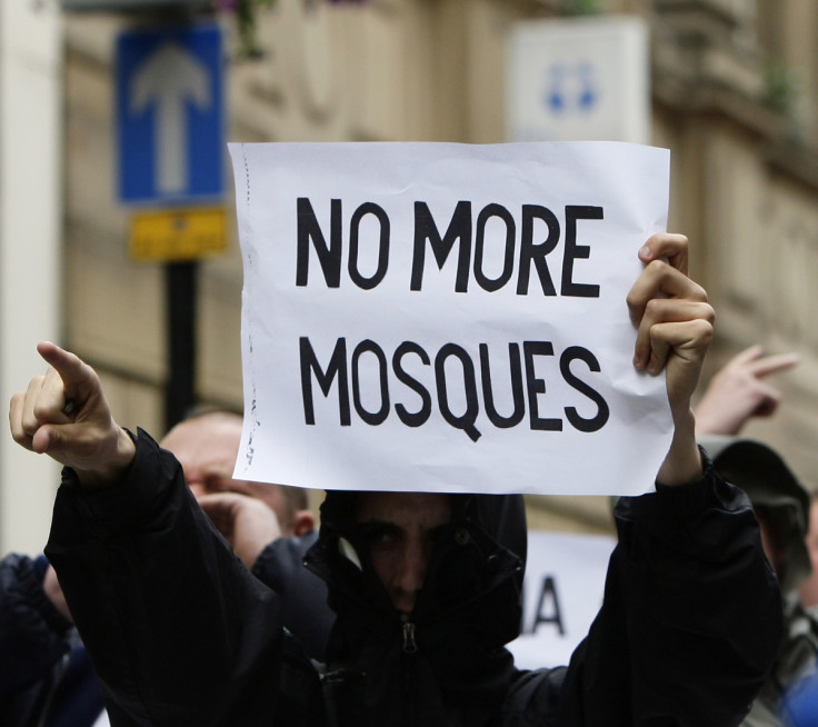 An EDL supporter holds up an anti-Islam message during a rally in Birmingham. (Reuters)