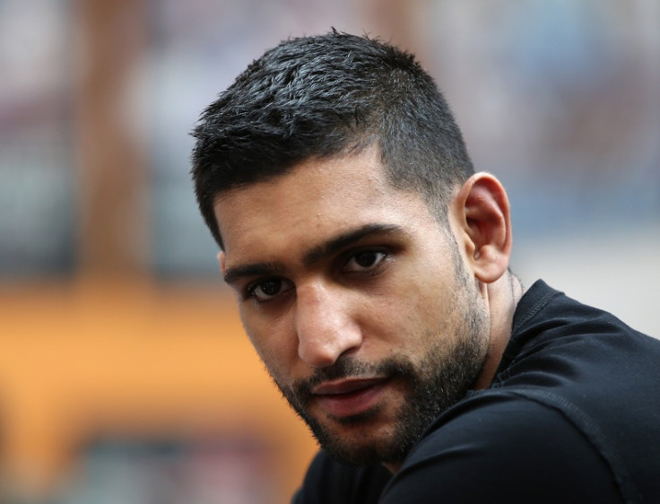Amir Khan was arrested over an alleged assault on two men in his hometown of Bolton