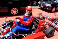 A real-life Mario driving his Mario Kart in Tokyo