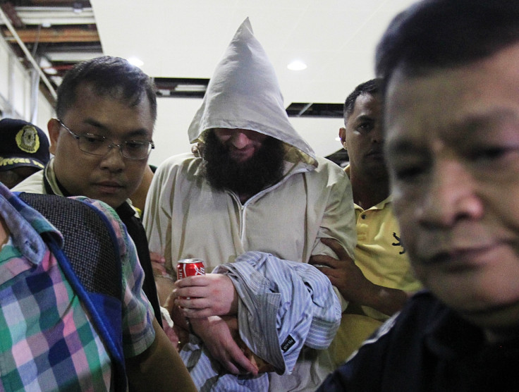 Cerantonio is led through manila Airport by Philippino authorities. (Reuters)