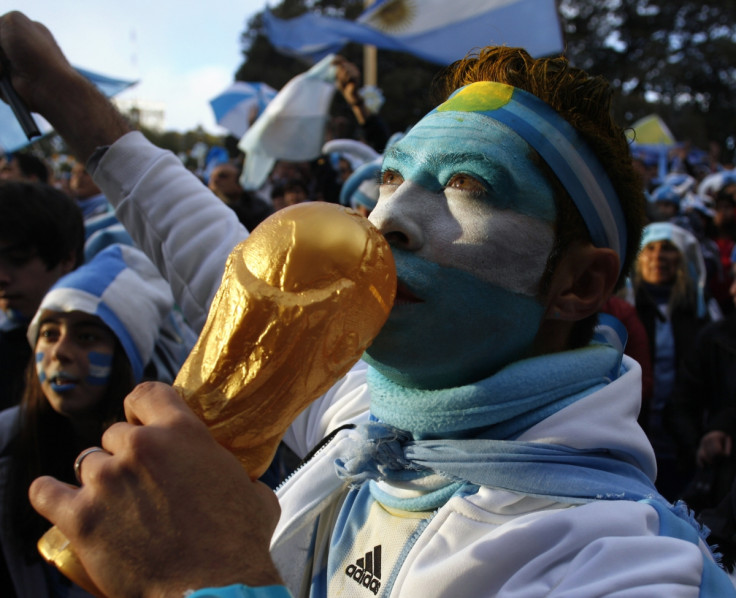 An Argentine fan holds a replica of the World Cup trophy in anticipation of a victory over Germany