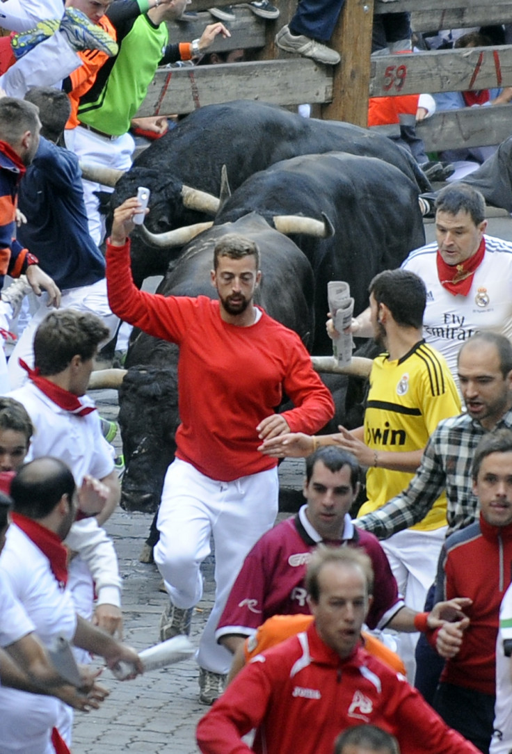 Man snaps selfie on Pamplona bull run. (Getty)