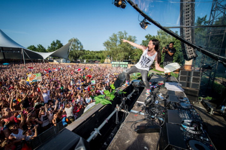 American DJ Steve Aoki throws a cream tart into the crowd during the first day of the Tomorrowland music festival, in Boom, on July 18, 2014.