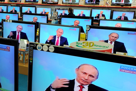 Russian president Vladimir Putin on television sets in a Moscow electronic goods store (Getty)