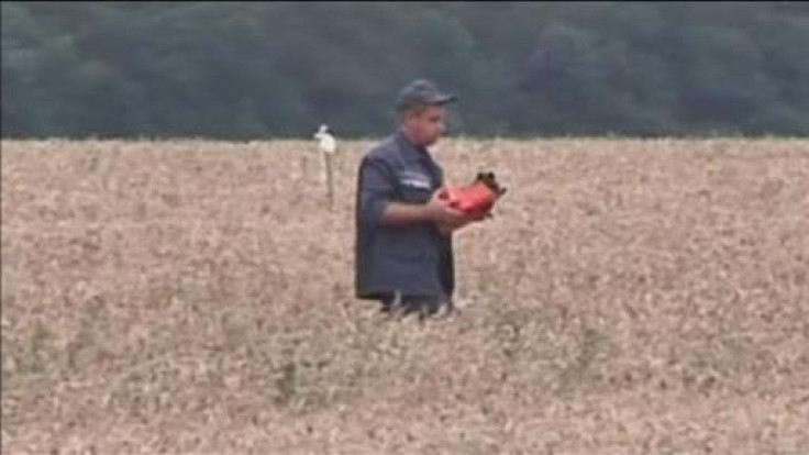 A still from the footage which shows a uniformed man in the militant controlled crash site removing the device.
