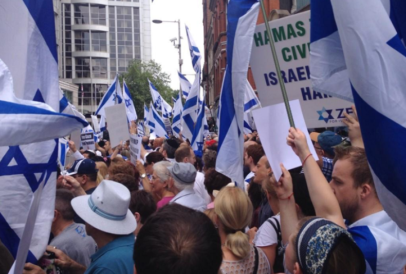 Protesters wave Israeli flags and pro-Israel placards at the demonstration in Kensington, west London.