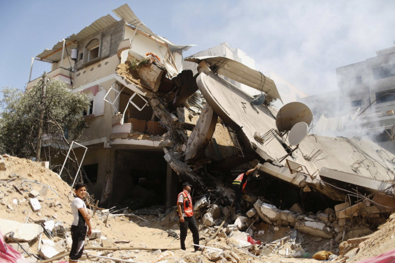 Palestinian rescue workers inspect house