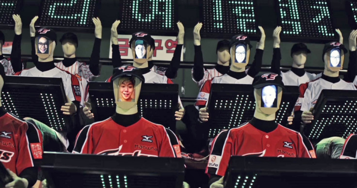 The faces of fans watching the game remotely are displayed on the robots