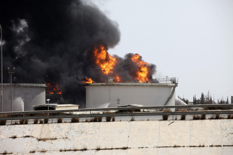 A general view shows fire burning at a fuel depot near the airport road in Tripoli