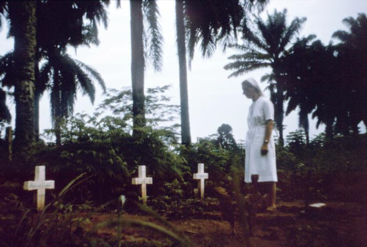 Nun visits graves of Ebola victims (Zaire (now Democratic Republic of Congo), 1976)