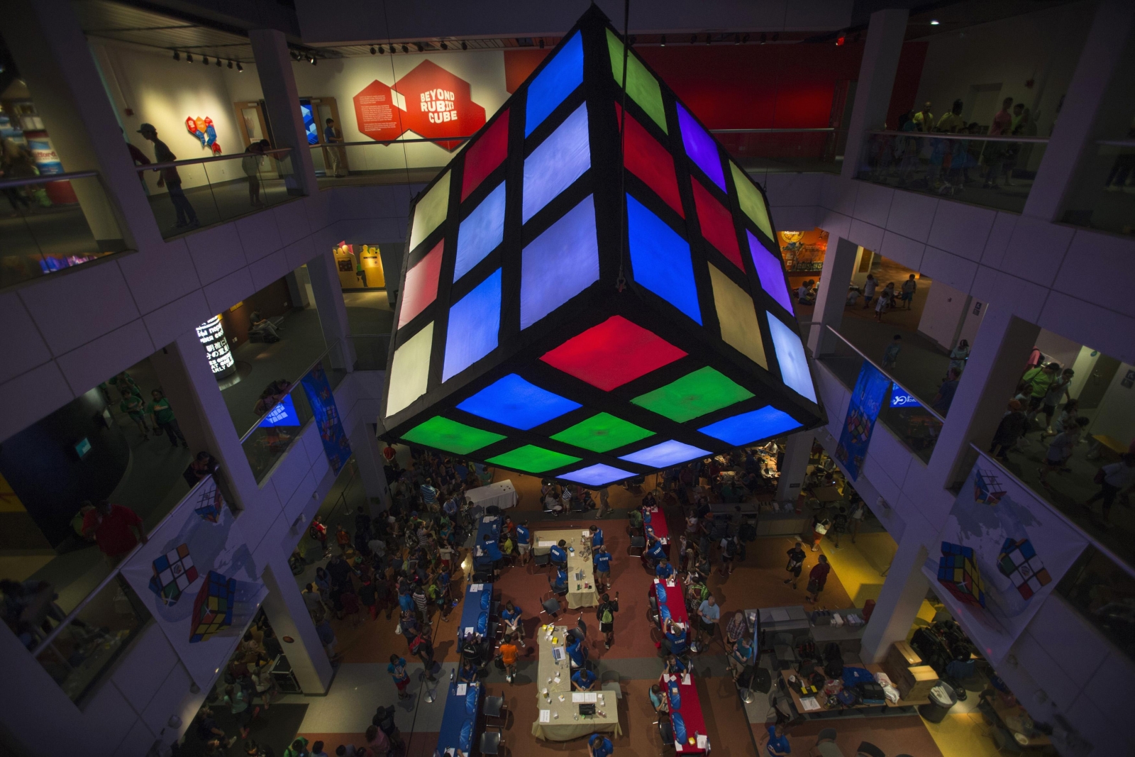 Rubiks Cube looks down over the crowd of participants