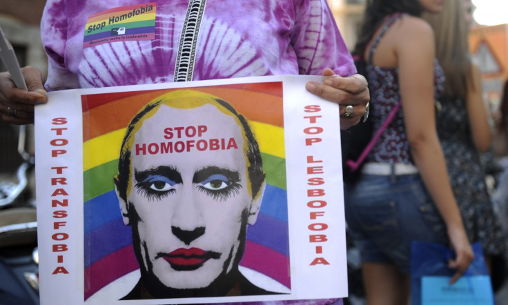 Protester holds up a picture of Putin in makeup at a Moscow gay rights rally. (AFP)