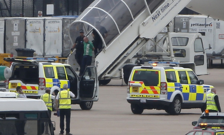A man is escorted off a Qatar Airways aircraft by police at Manchester airport in Manchester, northern England August 5, 2014. A British fighter jet escorted a passenger plane into Manchester airport on Tuesday afterthe pilot reported that a suspect devic A man is escorted off a Qatar Airways aircraft by police at Manchester airport in Manchester, northern England August 5, 2014. A British fighter jet escorted a passenger plane into Manchester airport on Tuesday afterthe pilot reported that a suspect devic