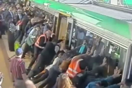 crowds pushing train to release man