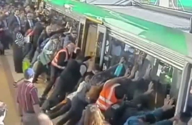 crowds pushing train to release man