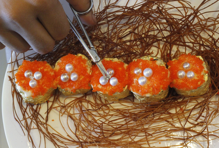 Renowned "Karat chef" Angelito Araneta Jr. places African diamonds on top of pearls to re-create his Guiness World Record for most expensive sushi in Manila