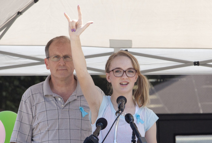 Cassidy Stay stands with her grandfather Roger Lyon (L) as she addresses the crowd during a memorial service