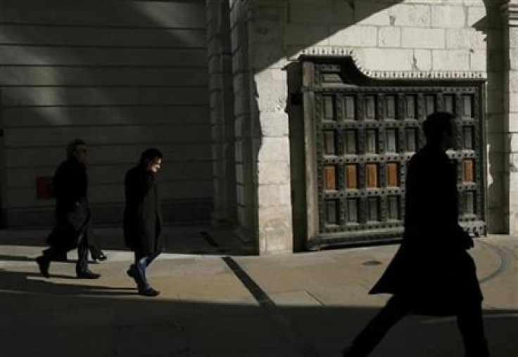 Pedestrians walk through the gate at Paternoster Square, home to the London Stock Exchange, London