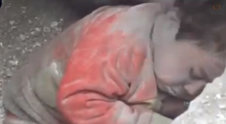Amateur video footage shows toddler being pulled alive from rubble.