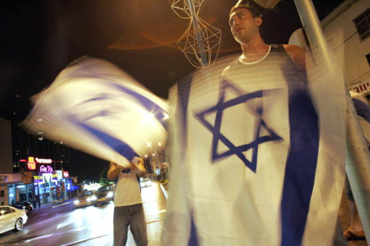 Israeli youths display their country's flag in Haifa (Yoav Lemmer AFP/Getty)