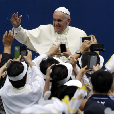 Pope Francis is greeted by the faithful upon his arrival for the Holy Mass at Daejeon World Cup stadium in Daejeon