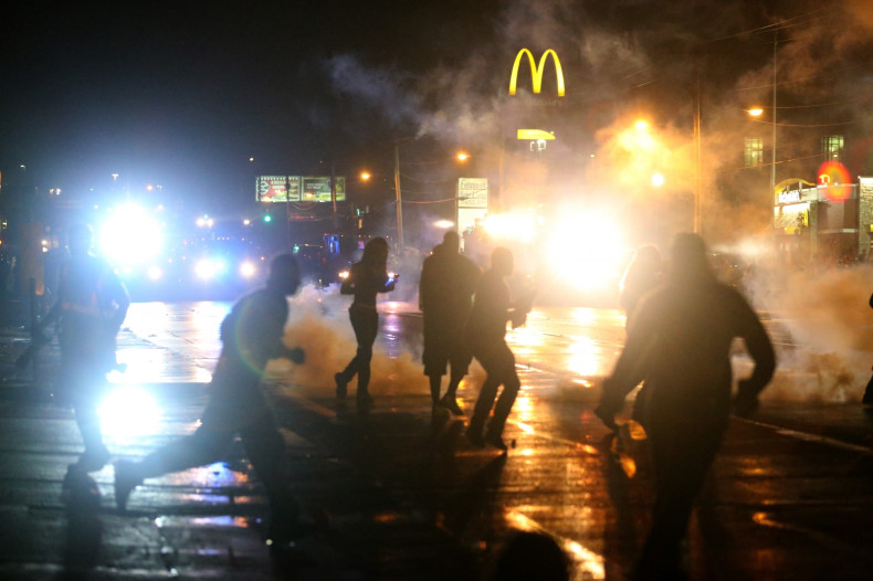 Police fire tear gas at protesters defying a curfew on the streets of Ferguson, Missouri (Getty)