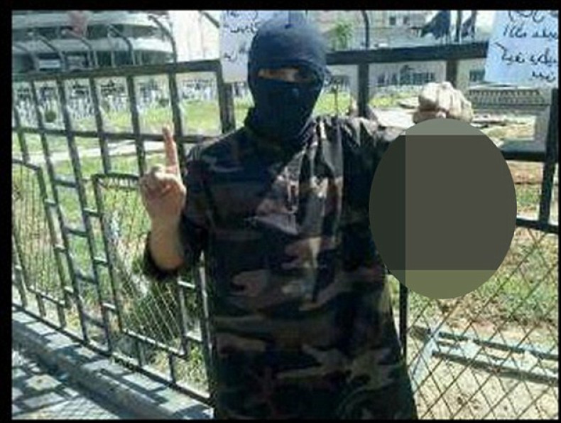 The photograph shows masked former rapper Abdel-Majed Abdel Bary, 23, holding the decapitated head while standing in Raqqa's central square