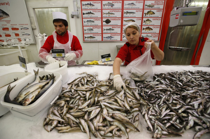 Employees work at the seafood department of an Auchan grocery store in Moscow, August 18, 2014.
