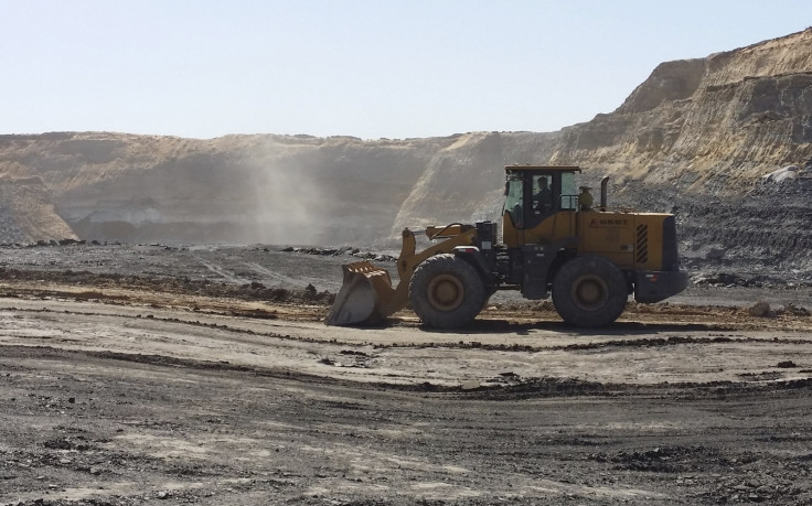 A mine worker drives a shovel truck across an open-cast coal mine located in the Ordos mining district, Inner Mongolia Autonomous Regio